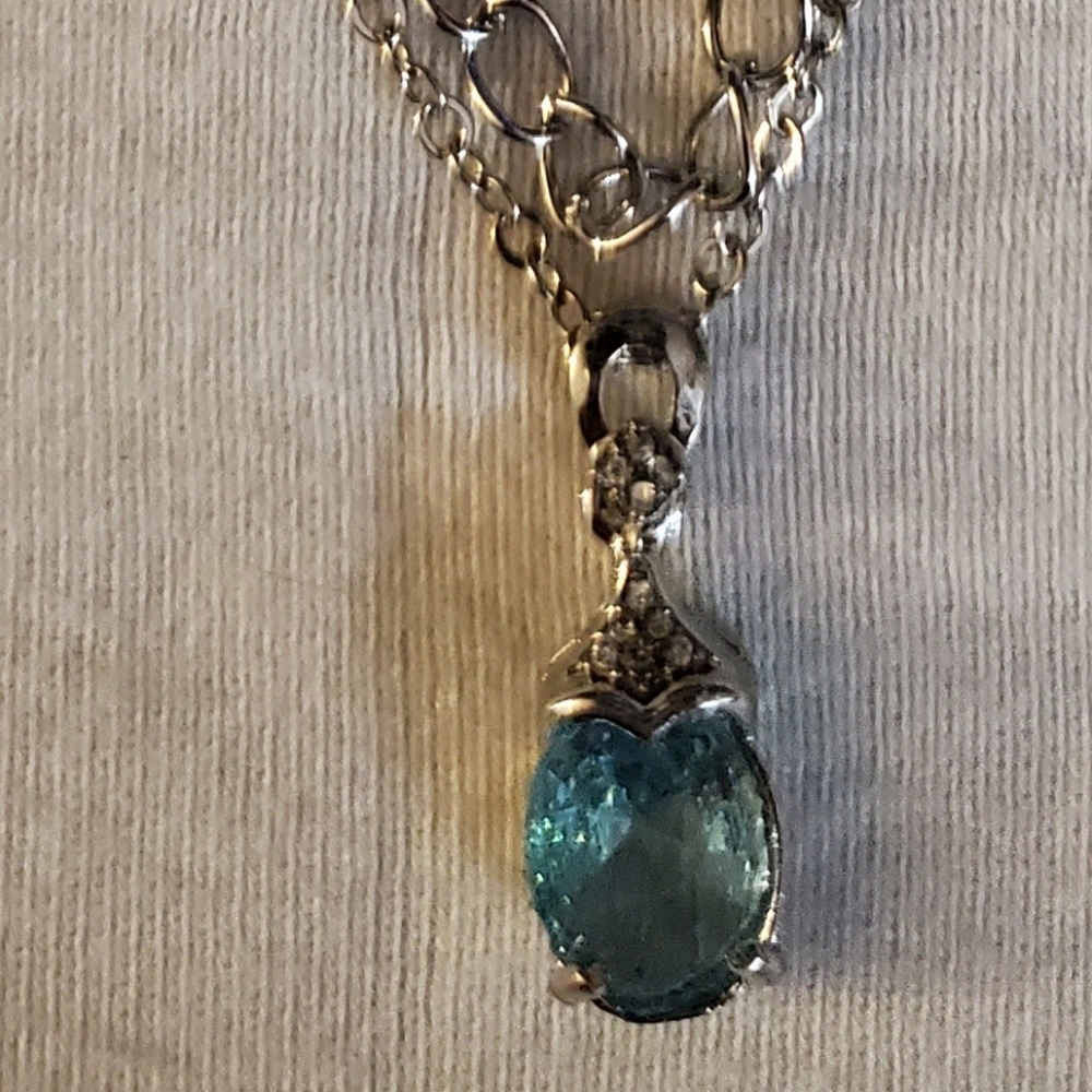 Silver tone necklace with faux aquamarine oval cut stone